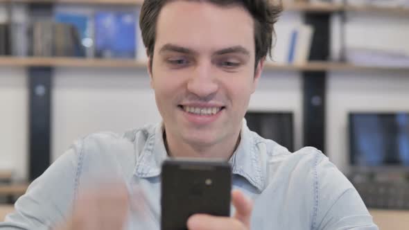 Portrait of Creative Man Excited for Success While Using Smartphon