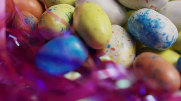 Rotating shot of colorful Easter candies on a bed of easter grass