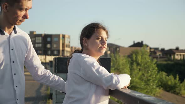 Young Disabled Man and Woman Stand on Bridge Smiling Closeup