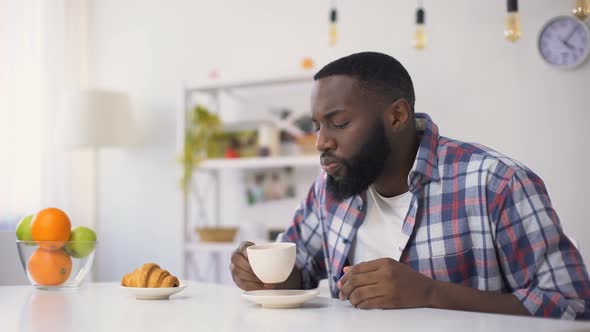 African-American Male Drinking Coffee, Coughing After Chocking With Beverage