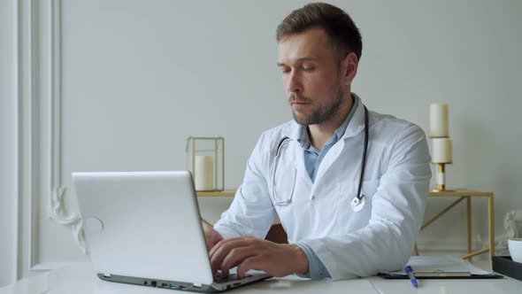 Doctor Using Laptop in Medical Office