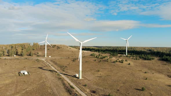 Three Wind Turbines Rotating on a Field