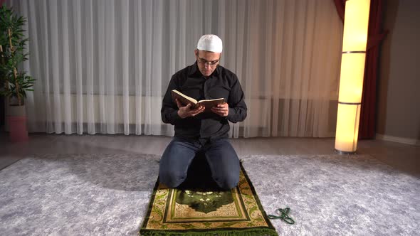 Muslim man reading quran.