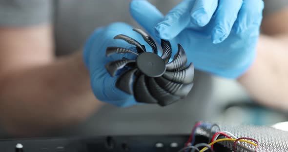 Cooler Computer Fan in Hands of Engineer Closeup