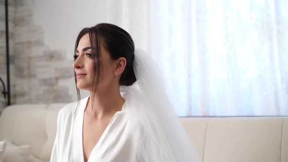 Bride Brunette in a White Robe She is Preparing for the Wedding Ceremony the Wedding Day