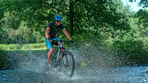 Super Slow Motion Shot of Man on Mountain Bike Crossing The River at 1000 Fps