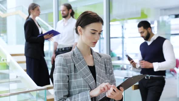 Business Woman With Folder In Hands At Working In Office