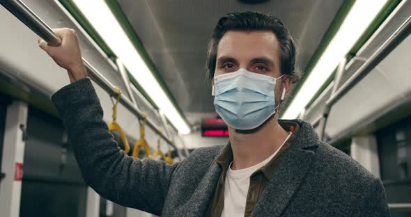 Close Up of Handsome Male Person in Protective Medical Mask Turning Head and Looking To Camera