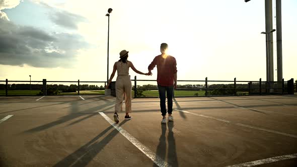 Young couple walking on parking deck