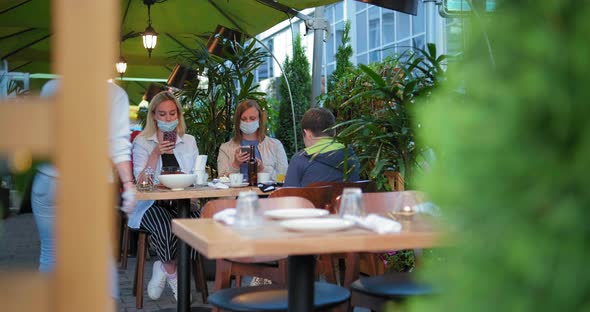 Waitress in Sterile Gloves Puts Food on Table