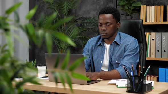 African American Businessman Works for Laptop Chatting with Company Employees