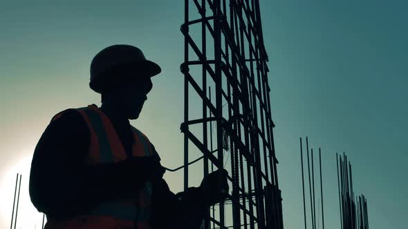 Metal Construction Is Getting Adjusted By a Male Worker