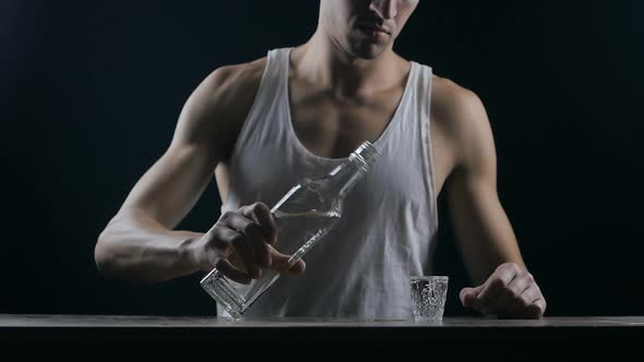 Depressed Man Drinking Vodka in a Dark Room