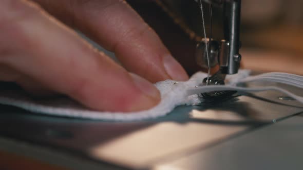 Tailor at Sewing Machine Sews a Homemade Medical Face Mask To Protect Covid-19