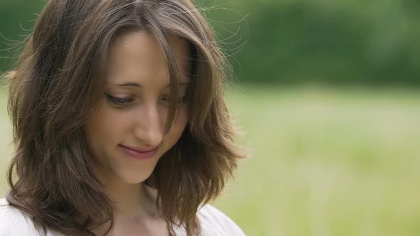 Shy Beautiful Young Woman With Brown Hair Smiles Looking Down Outdoor Nature