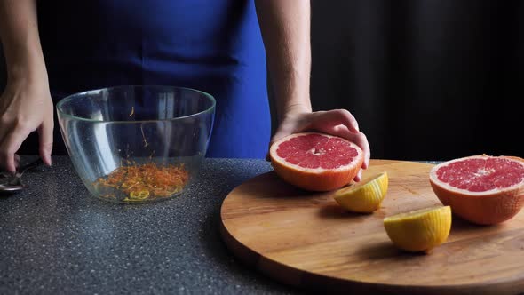 Citrus fruit - squeezing a grapefruit by hand