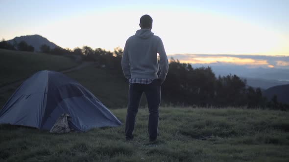 Young Man Looking Around Panorama in Nature Mountain Outdoor at Sunrise or Sunset