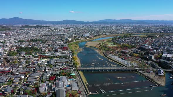 Aerial view 4k by drone of Katsura river at autumn and boats. Arashiyama, Kyoto