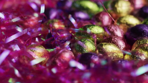 Rotating shot of colorful Easter candies on a bed of easter grass