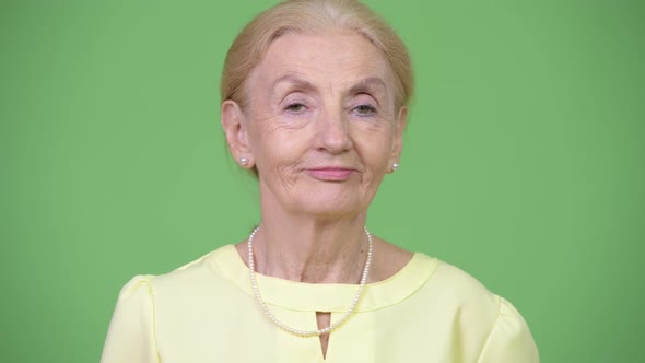 Studio Shot of Happy Senior Businesswoman with Blond Hair