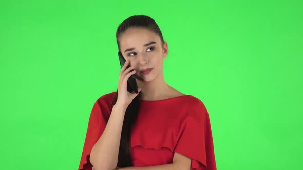 Portrait of Pretty Young Woman Is Talking for Mobile Phone. Green Screen