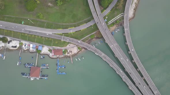 Aerial view busy traffic interchange beside sea