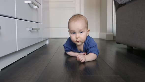 Cute Six Month Old Baby Boy Crawling on Floor to Camera