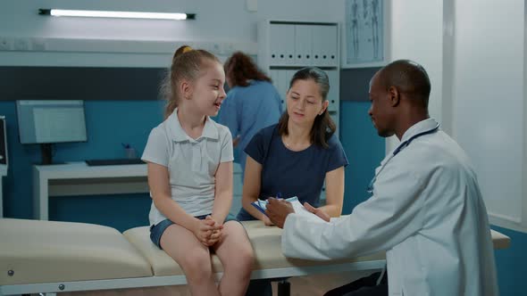 Little Girl and Doctor Doing Medical Consultation in Office