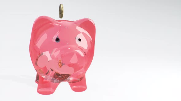 Coins Fall Into a Pink Glass Piggy Bank - a Symbol of Wealth, Frugality and Effective Investment