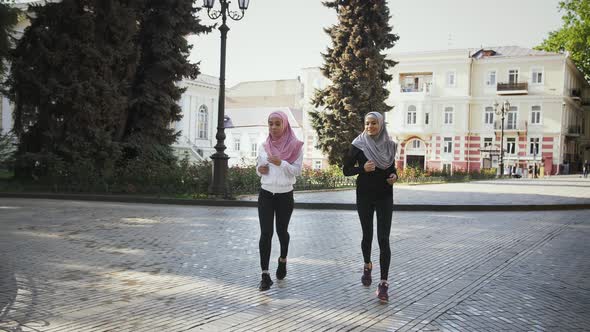 Two Muslim Females in Sport Clothes and Colorful Hijabs