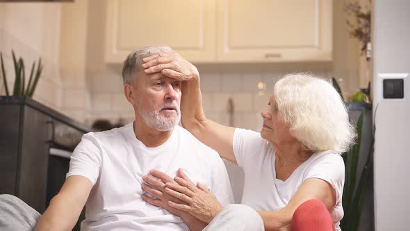 Man of Retirement Age Is Sitting on the Floor He Feels Bad After Playing Sports His Wife Is Sitting