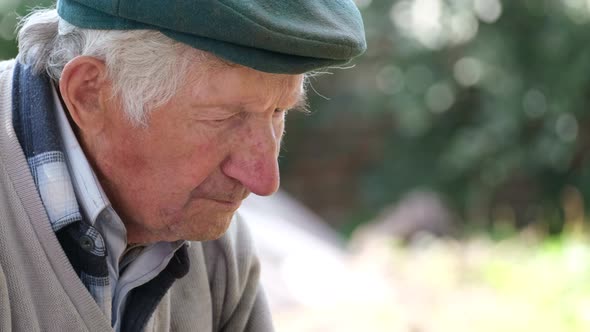 Upset Old Grandfather with Looking Down Side View