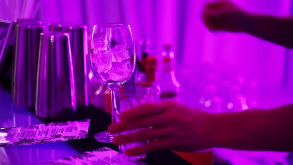 Close Up Hands of the Bartender Making a Cocktail at the Bar Counter