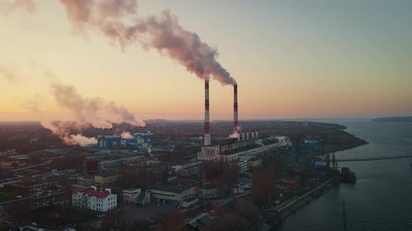 Aerial view of high smoke stack with smoke emission