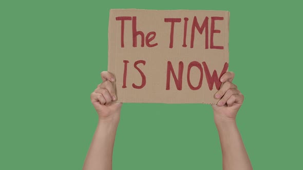 Showing Cardboard Poster with Inscription THE TIME IS NOW. Human Rights Demonstration. Hands Holding