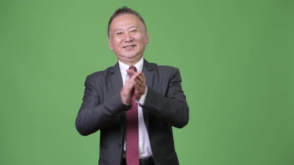 Mature Happy Japanese Businessman Clapping Hands