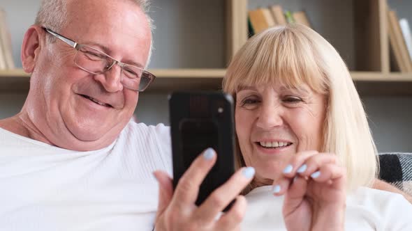 Closeup of the Faces of a Husband and Wife Searching the Internet