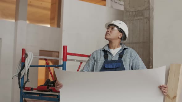 Architect Holding Paper on Construction Object