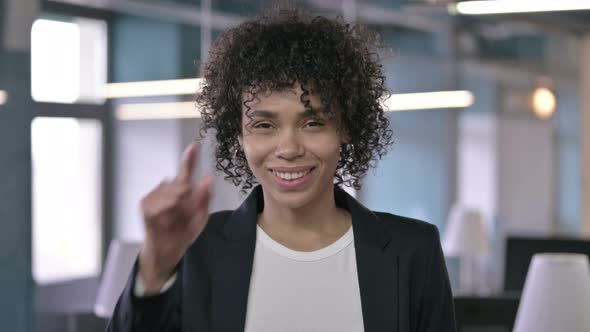 Portrait of Cheerful Businesswoman Pointing Finger at Camera and Inviting