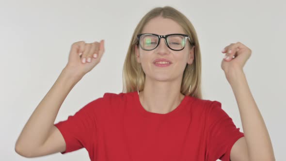 Young Woman Dancing in Joy on White Background