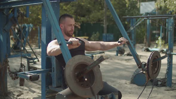 Fit Strong Man Exercising Vertical Chest Press