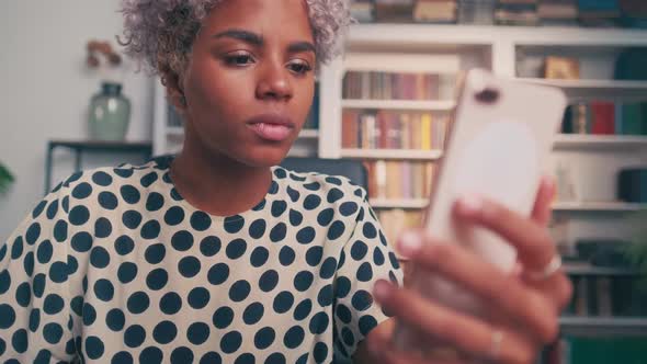 Excited Attractive Woman with Mobile Phone Receives Notification of Winning