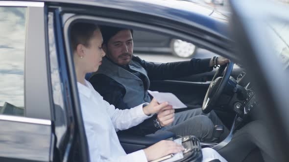 Serious Man Passing Envelope with Cash to Woman Sitting in Car