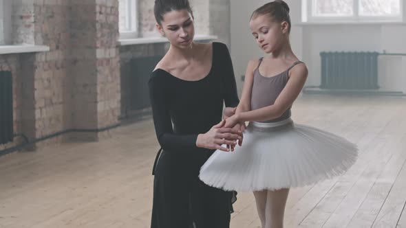 Ballet Tutor Teaching Pretty Girl In Dance Studio