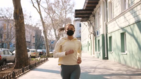 Portrait of Beautiful Young and Fit Woman Running and Jogging Alone on the Empty Street in City