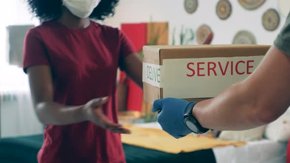 Self-quarantined African Woman Is Accepting a Package