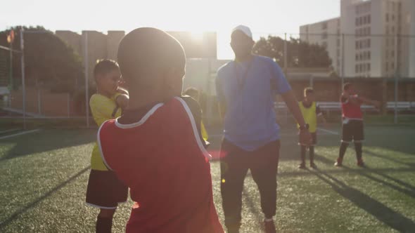 Soccer kids exercising in a sunny day