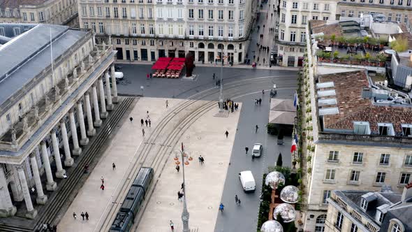 Bordeaux or Opera house Grand Theater square with people walking and trolley passing by, Aerial pede