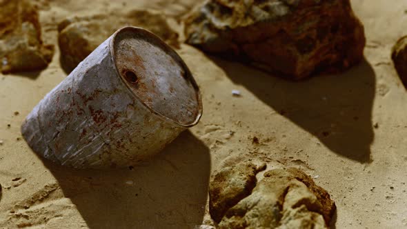 Rusty Metal Oil Barrel on Sand Beach