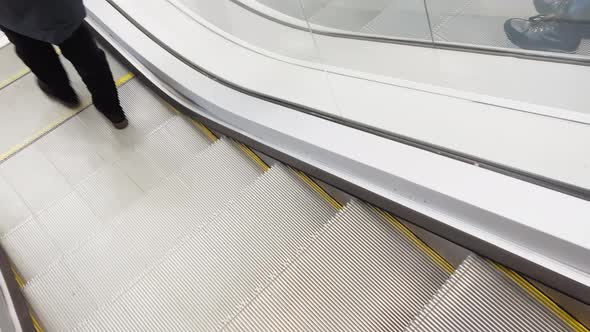 First Person View of Close Up Footage of Moving Empty Modern Escalator Stairs Glass Railings